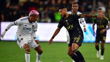 Oct 20, 2022; Los Angeles, California, US; Los Angeles FC forward Denis Bouanga (99) dribbles against Los Angeles Galaxy defender Julian Araujo (2) during the first half of the MLS Cup Playoff semifinal at Banc Of California Stadium. Mandatory Credit: Gary A. Vasquez-USA TODAY Sports