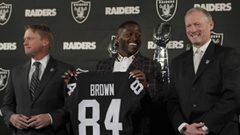 Oakland Raiders wide receiver Antonio Brown, center, holds his jersey beside coach Jon Gruden, left, and general manager Mike Mayock during an NFL football news conference Wednesday, March 13, 2019, in Alameda, Calif. (AP Photo/Ben Margot)