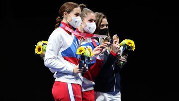 Silver medalist Sofya Velikaya of Team ROC, gold medalist Sofia Pozdniakova of Team ROC, and bronze medalist Manon Brunet of Team France, pose on the podium during the medal ceremony for Women&#039;s Sabre Individual Fencing. 