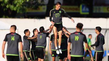 Hector Moreno is lifted up into the air by his team mates during a fun Mexico training session.