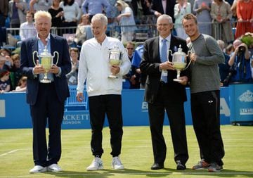 Germany's Boris Becker, USA's John McEnroe, Australia's Roy Emerson and Lleyton Hewitt pose with quarter size Queens Club trophies after each won the tournament four times.