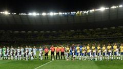 Players of Argentina (L) and Brazil listen to their national anthems before the start of their 2018 FIFA World Cup qualifier football match in Belo Horizonte, Brazil, on November 10, 2016. / AFP PHOTO / DOUGLAS MAGNO
