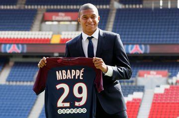 Soccer Football - Paris St Germain - Kylian Mbappe Press Conference - Paris, France - September 6, 2017. New Paris St Germain signing Kylian Mbappe poses with the club shirt after a press conference.    