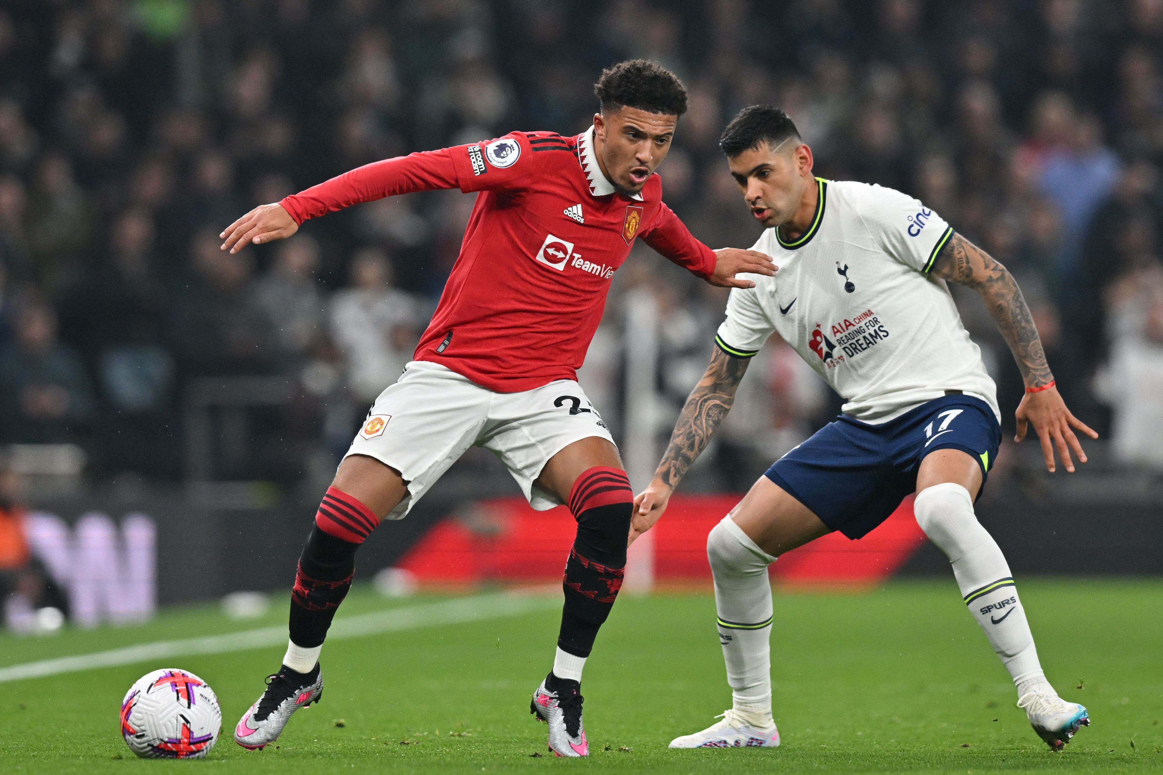 Manchester United's English striker Jadon Sancho (L) vies with Tottenham Hotspur's Argentinian defender Cristian Romero (R) during the English Premier League football match between Tottenham Hotspur and Manchester United at Tottenham Hotspur Stadium in London, on April 27, 2023. (Photo by Glyn KIRK / AFP) / RESTRICTED TO EDITORIAL USE. No use with unauthorized audio, video, data, fixture lists, club/league logos or 'live' services. Online in-match use limited to 120 images. An additional 40 images may be used in extra time. No video emulation. Social media in-match use limited to 120 images. An additional 40 images may be used in extra time. No use in betting publications, games or single club/league/player publications. / 