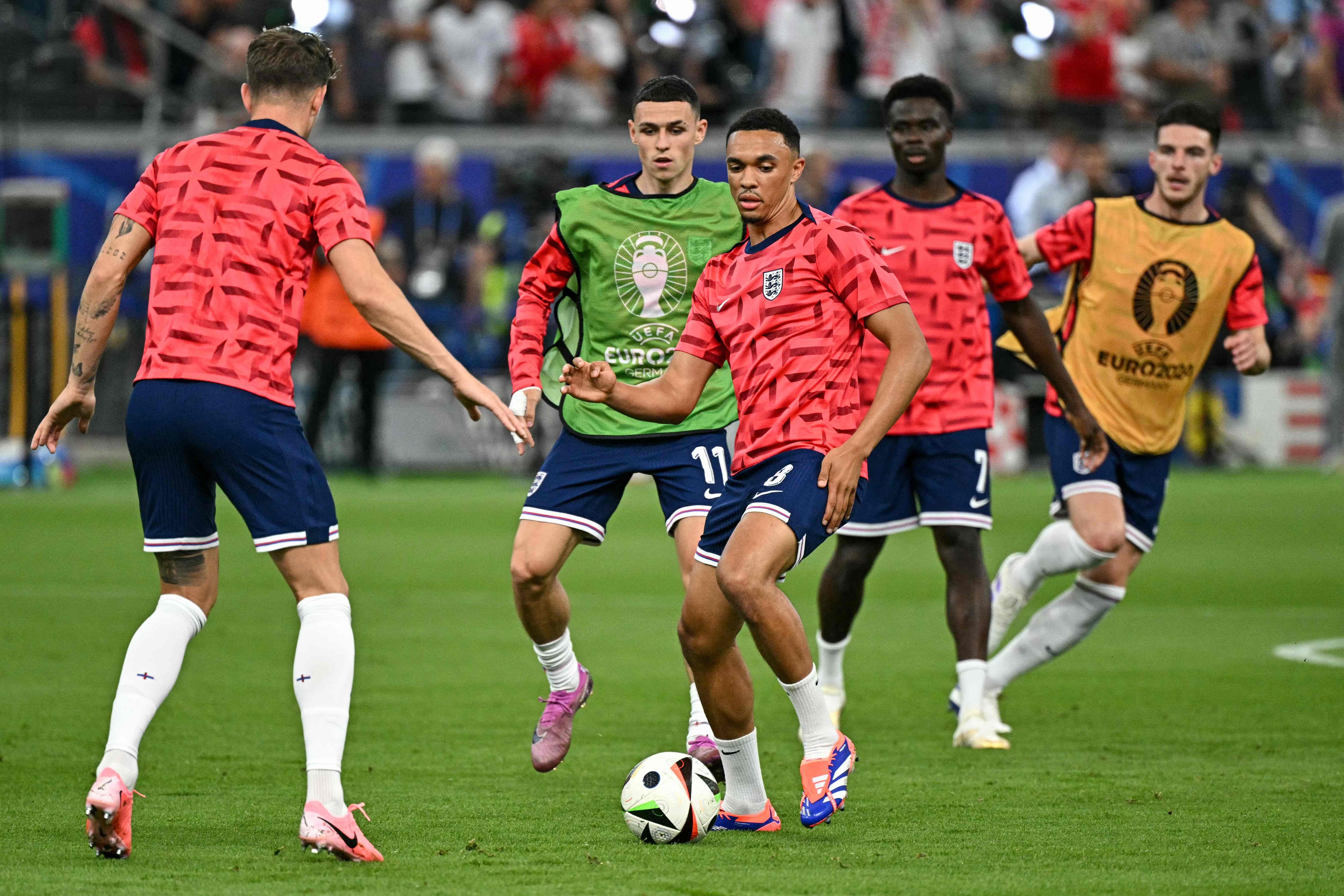 England's midfielder #11 Phil Foden (C-L), England's defender #08 Trent Alexander-Arnold (C), England's forward #07 Bukayo Saka (2ndR) and England's midfielder #04 Declan Rice warm up ahead of the UEFA Euro 2024 Group C football match between Denmark and England at the Frankfurt Arena in Frankfurt am Main on June 20, 2024. (Photo by JAVIER SORIANO / AFP)