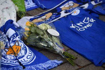 Hand-written messages are attached to bunches of flowers on a growing pile of tributes outside Leicester City Football Club's King Power Stadium
