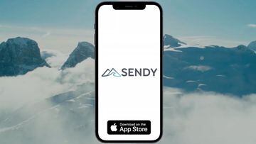 Un tel&eacute;fono iOS con la app Sendy abri&eacute;ndose y, al fondo, monta&ntilde;as nevadas.