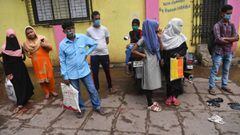 Residents wait to collect their test results for Covid-19 coronavirus atxA0a civic clinic in Dharavi slums, in Mumbai on October 12, 2020. - India&#039;s coronavirus cases surged past seven million on October 11 as US President Donald Trump got back on th
