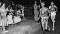 Abebe Bikila of Ethiopia, running barefoot, draws away from Abdesselem Rhadi of Morocco near the finish of the marathon at the 1960 Rome Olympics. He went on to win with a new Olympic record time of 2 hours 15 minutes 16 seconds.   (Photo by Central Press