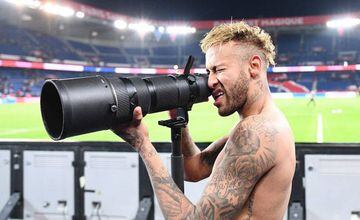Paris Saint-Germain's Brazilian forward Neymar pretends to take pictures of his team mates as they celebrate winning the French L1 football match between Paris Saint-Germain (PSG) and Olympique de Lyon (OL) on October 7, 2018 at the Parc des Princes stadi