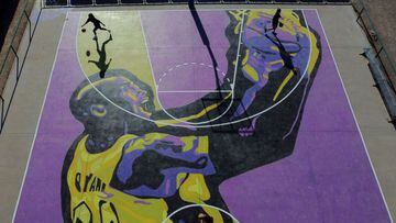 Women play basketball on a municipal basketball court painted with an image of the legendary basketball star Kobe Bryant, who died in a helicopter crash in January 26, 2020 in U.S., in Balaguer, Spain January 25, 2022. Picture taken with a drone. REUTERS/