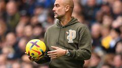 Manchester City's Spanish manager Pep Guardiola returns the ball during the English Premier League football match between Manchester City and Brentford at the Etihad Stadium in Manchester, north west England, on November 12, 2022. (Photo by Oli SCARFF / AFP) / RESTRICTED TO EDITORIAL USE. No use with unauthorized audio, video, data, fixture lists, club/league logos or 'live' services. Online in-match use limited to 120 images. An additional 40 images may be used in extra time. No video emulation. Social media in-match use limited to 120 images. An additional 40 images may be used in extra time. No use in betting publications, games or single club/league/player publications. / 