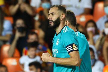 Real Madrid's French forward Karim Benzema celebrates scoring his team's second goal during the Spanish League football match between Valencia CF and Real Madrid CF at the Mestalla stadium in Valencia on September 19, 2021.