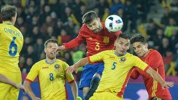 Spains defender Gerard Pique and Romanias defender Ovidiu Stefan Hoban vie for the ball during the friendly football match between Romania and Spain in Cluj Napoca, Romania