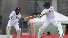 Opener Azhar Ali of Pakistan plays a cover shot as West Indies wicketkeeper Shai Hope  looks on during the first day of play, of the 3rd and final test match at the Windsor Park Stadium in Roseau, Dominica on May 10, 2017.