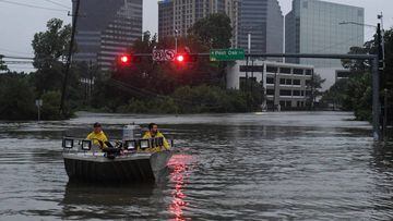 Rescue crews search for people in distress after Hurricane Harvey caused heavy flooding in Houston, Texas on August 27, 2017. 
 Massive flooding unleashed by deadly monster storm Harvey left Houston -- the fourth-largest city in the United States -- increasingly isolated as its airports and highways shut down and residents fled homes waist-deep in water. / AFP PHOTO / MARK RALSTON