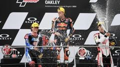 (From L) Second-placed USA&#039;s Joe Roberts, race winner Spain&#039;s Pedro Acosta and third-placed Japan&#039;s Ai Ogura celebrate on the podium after competing in the Moto 2 race of the Italian Moto GP Grand Prix at the Mugello race track, Tuscany, on