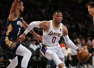 Feb 27, 2022; Los Angeles, California, USA; Los Angeles Lakers guard Russell Westbrook (0) is defended by New Orleans Pelicans guard CJ McCollum (3) as he drives to the basket in the first half at Crypto.com Arena. Mandatory Credit: Jayne Kamin-Oncea-USA 