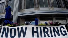 (FILES) In this file photo a restaurant displays a &quot;Now Hiring&quot; sign amid the coronavirus pandemic, on August 4, 2020 in Arlington, Virginia. - New filings for US unemployment benefits declined again last week, hitting their lowest level since t