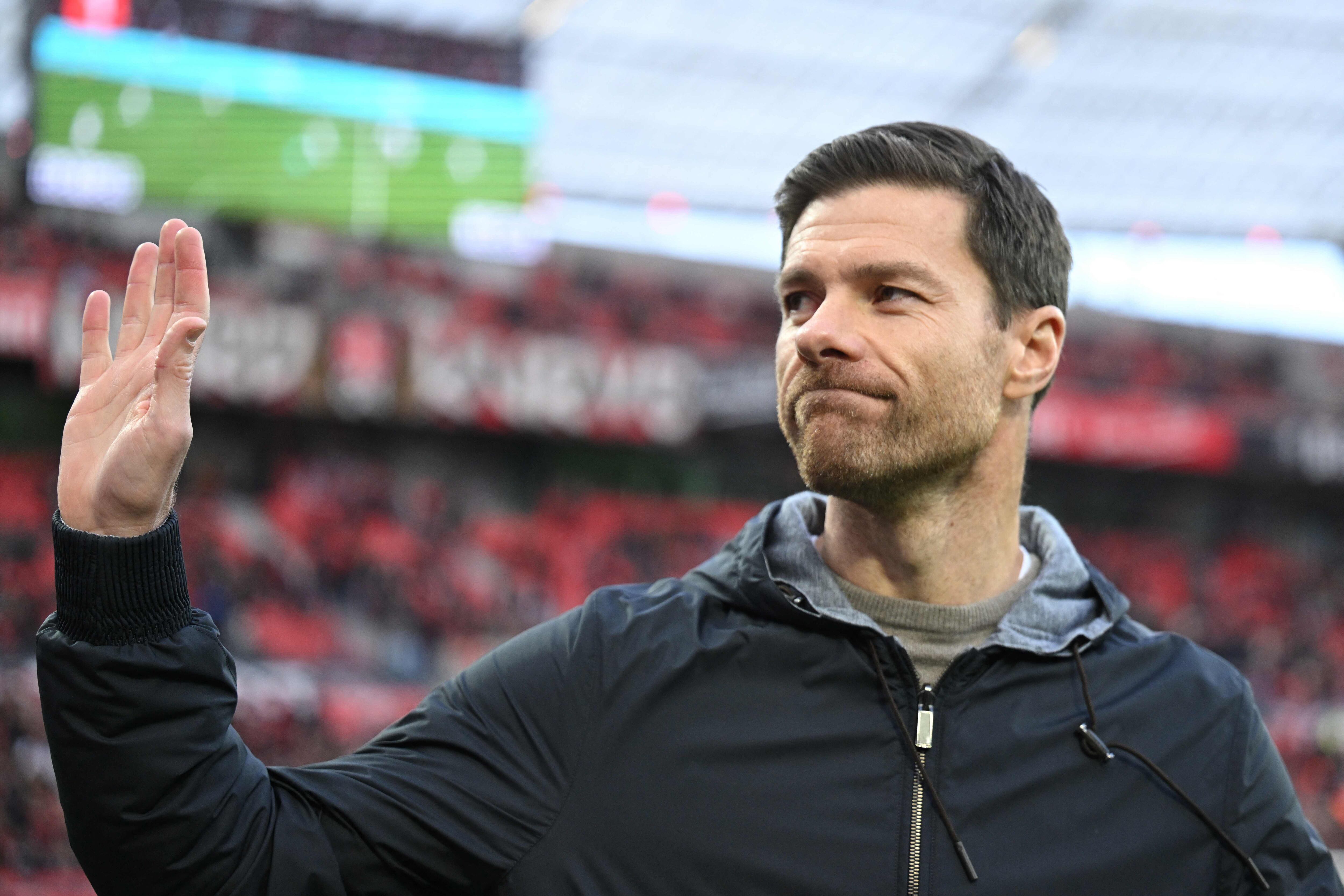 Bayer Leverkusen's Spanish coach Xabi Alonso waves at the start of the German first division Bundesliga football match Bayer 04 Leverkusen v 1 FC Union Berlin in Leverkusen, western Germany on November 12, 2023. (Photo by INA FASSBENDER / AFP) / DFL REGULATIONS PROHIBIT ANY USE OF PHOTOGRAPHS AS IMAGE SEQUENCES AND/OR QUASI-VIDEO