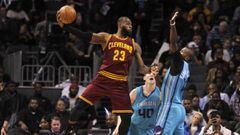 Dec 31, 2016; Charlotte, NC, USA; Cleveland Cavaliers forward LeBron James (23) passes the ball as he is defended by Charlotte Hornets forward Michael Kidd-Gilchrist (14) and forward center Cody Zeller (40) during the second half of the game at the Spectr