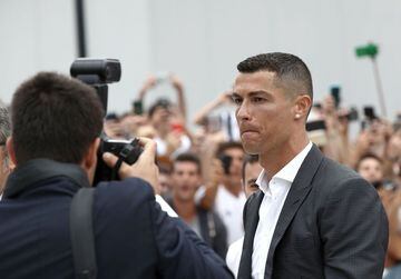 Portuguese attacker Cristiano Ronaldo walks out the Juventus medical center at the Alliance stadium in Turin on July 16, 2018 to greet supporters.