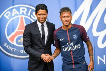 Brazilian superstar Neymar shaking hands with Paris Saint Germain's Qatari president Nasser Al-Khelaifi after agreeing a five-year contract following his world record 222 million euro ($260 million) transfer from Barcelona to PSG.