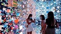 Visitors are pictured in front of an immersive art installation titled &quot;Machine Hallucinations &mdash; Space: Metaverse&quot; by media artist Refik Anadol, which was auctioned as an NFT in September.