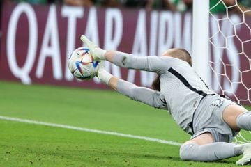 Andrew Redmayne makes the winning penalty save in Australia's shootout victory over Peru.