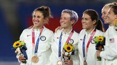 TOKYO, JAPAN - AUGUST 06: Bronze medalists Carli Lloyd , Megan Rapinoe and Kelley O&#039;Hara of Team United States (C) react with their bronze medal during the Women&#039;s Football Competition Medal Ceremony during the Gold Medal Match Women&#039;s Foot