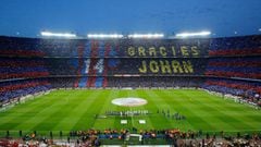 (FILES) This file photo taken on April 2, 2016 shows football supporters holding-up coloured rectangular posters to form a giant mosaic reading, &quot;Thankyou Johan&quot;, in tribute to late Dutch football player Johan Cruyff before the Spanish league &q