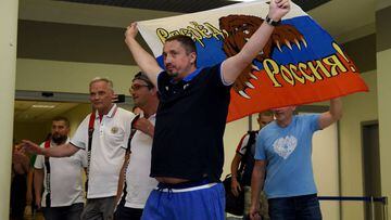 This file photo taken on June 18, 2016 shows Russia&#039;s football fans leader Alexander Shprygin holding a flag as he leaves with others fans the international airport Sheremetevo near Moscow late on June 18, 2016 after being expulsed from France after 
