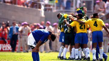 17 July 1994 World Cup Final 1994, Brazil v Italy - Los Angeles, Roberto Baggio has his hands on his knees in despair as the Brazilian team celebrate his missed penalty which won them the world cup. (Photo by Mark Leech/Getty Images)