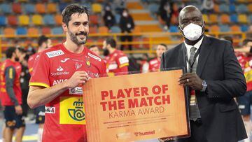 Spain&#039;s centre back Raul Entrerrios (L) is awarded player of the game during the 2021 World Men&#039;s Handball Championship match between Group I teams Spain and Germany at the New Capital Sports Hall in the Egyptian capital Cairo on January 21, 202