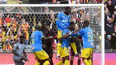 Lens&#039;s french midfielder Kevin Danso (2R) celebrates with teammates after scoring during the French L1 football match between RC Lens and Clermont Foot 63 at Stade Bollaert-Delelis in Lens, northern France, on March 19, 2022. - Lens team plays with a