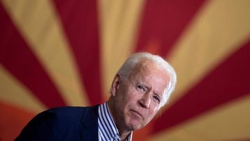 (FILES) In this file photo taken on October 8, 2020 Democratic presidential candidate former US Vice President Joe Biden pauses while speaking to supporters in front of an Arizona state flag, at the United Brotherhood of Carpenters and Joiners of America&