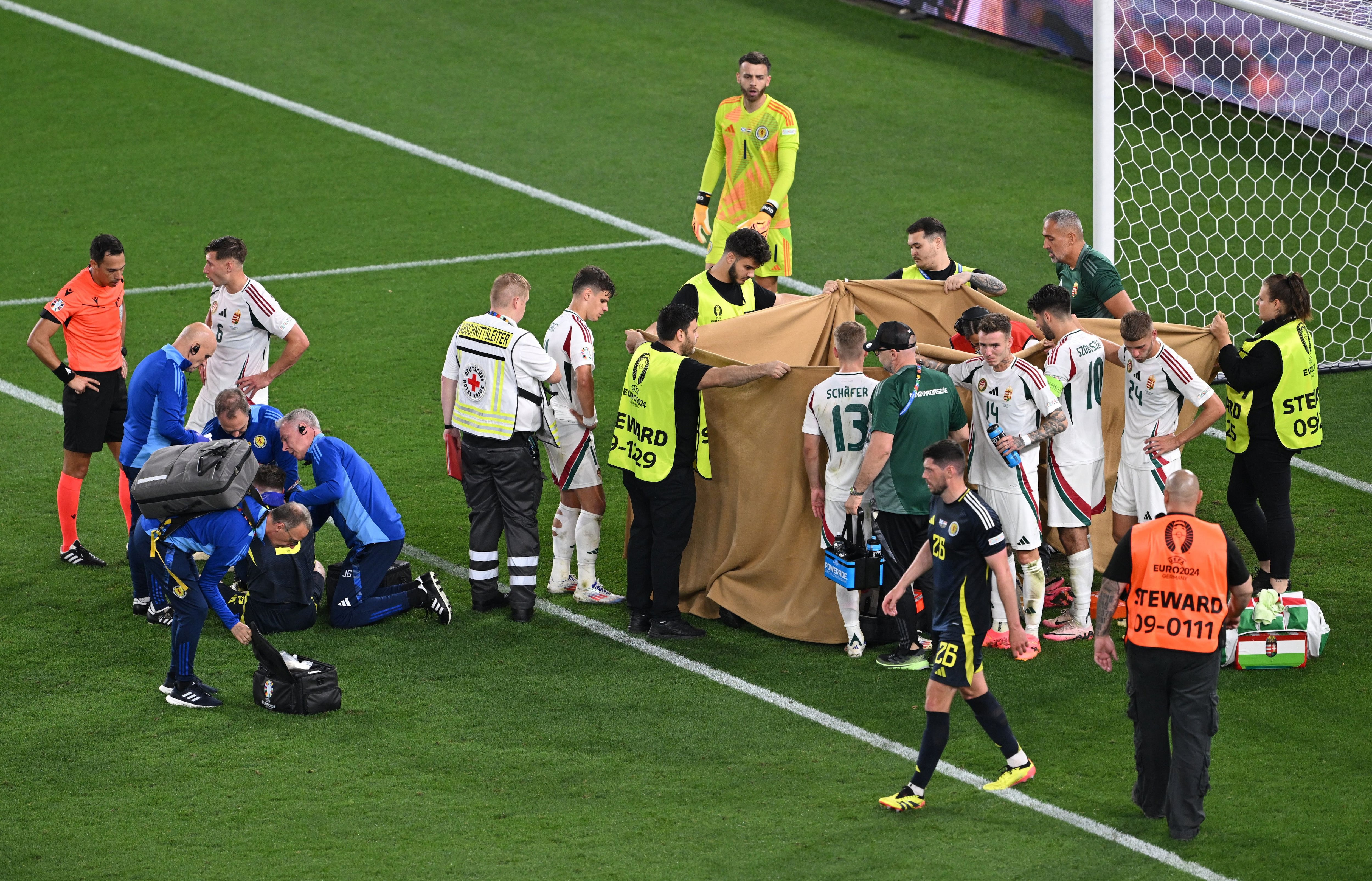 Soccer Football - Euro 2024 - Group A - Scotland v Hungary - Stuttgart Arena, Stuttgart, Germany - June 23, 2024 Hungary's Barnabas Varga receives medical attention after sustaining an injury REUTERS/Angelika Warmuth