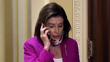 House Speaker Nancy Pelosi talks on her phone at the US Capitol on May 15, 2020 in Washington, DC. - US House Democrats aim to pass a record $3 trillion coronavirus response package Friday to fund the fight against the pandemic and provide emergency payme