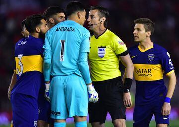 BUENOS AIRES, ARGENTINA - OCTOBER 01: Esteban Andrada and Emmanuel Mas of Boca Juniors argue with referee Raphael Claus after reviewing a play on the VAR and calling a penalty for River Plate during the semi final first leg match between River Plate and B