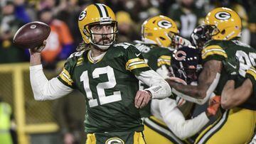 Dec 12, 2021; Green Bay, Wisconsin, USA; Green Bay Packers quarterback Aaron Rodgers (12) throws a touchdown pass to wide receiver Davante Adams (not pictured) in the fourth quarter against the Chicago Bears at Lambeau Field. Mandatory Credit: Benny Sieu-