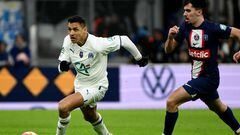 Marseille's Chilean forward Alexis Sanchez (L) fights for the ball with Marseille's Portuguese forward Vitinha during the French Cup round of 16 football match between Olympique Marseille (OM) and Paris Saint-Germain (PSG) at Stade Velodrome in Marseille, southern France on February 8, 2023. (Photo by CHRISTOPHE SIMON / AFP)