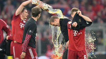 Benjamin Pavard pours beer over Julian Nagelsmann after Bayern secured a 10th consecutive Bundesliga title.