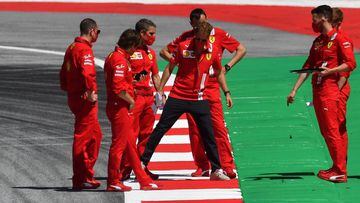 Ferrari&#039;s German driver Sebastian Vettel (C) and his team inspect the track on July 1, 2020, on the eve of the first practice session at the Austrian Formula One Grand Prix in Spielberg, Austria. - Seven months after they last competed in earnest, th
